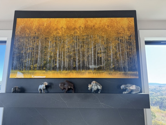 A large canvas of a golden aspen grove hangs above the fireplace at 2111 Vantage Circle