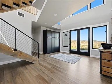 The entry foyer has a dark blue built-in cabinet