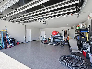 The garage has a speckled epoxy floor