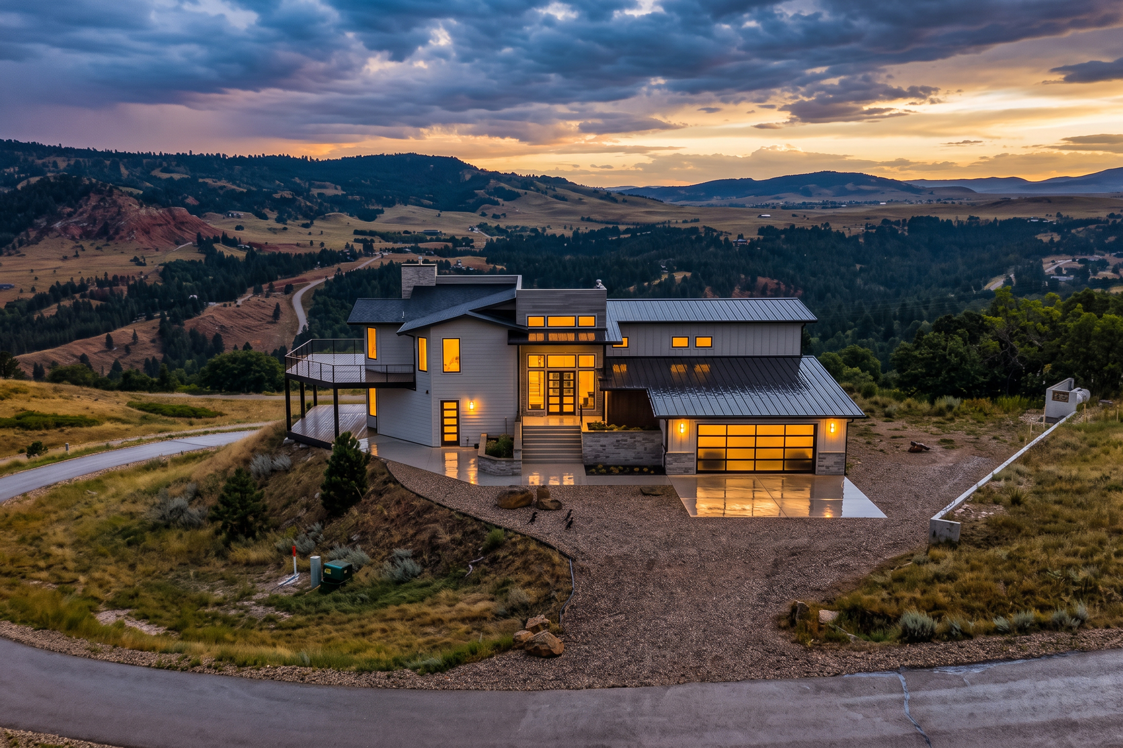 An aerial dusk photograph shows the residence perched on its ridge