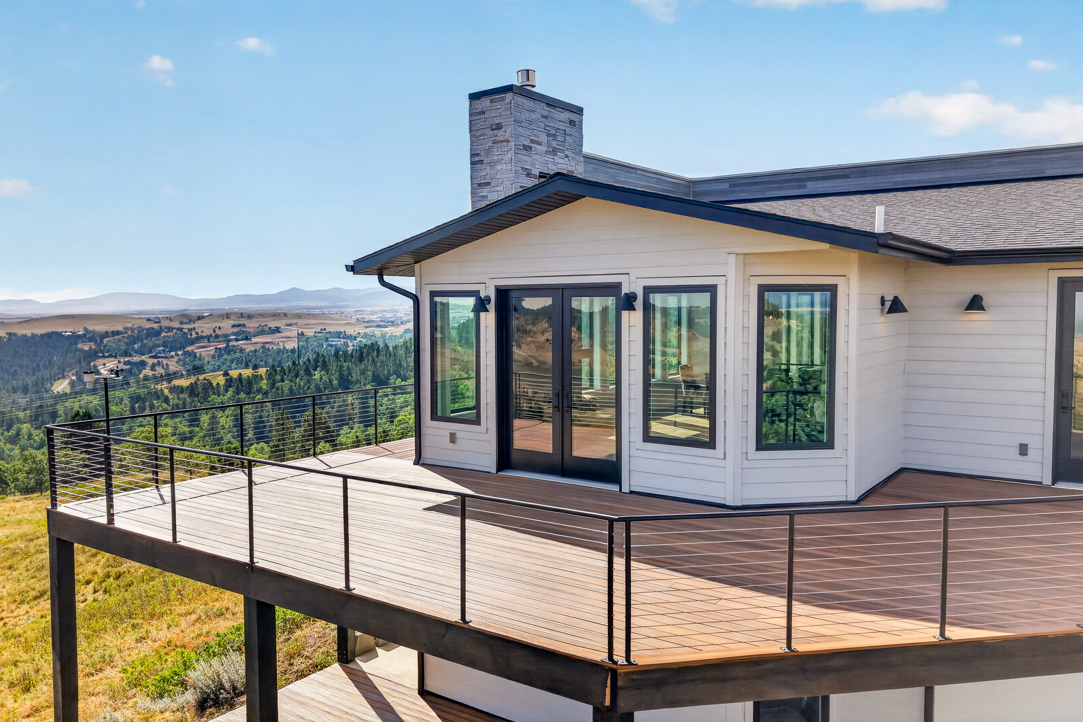 The upper deck wraps around a bay-windowed room at 2111 Vantage Circle